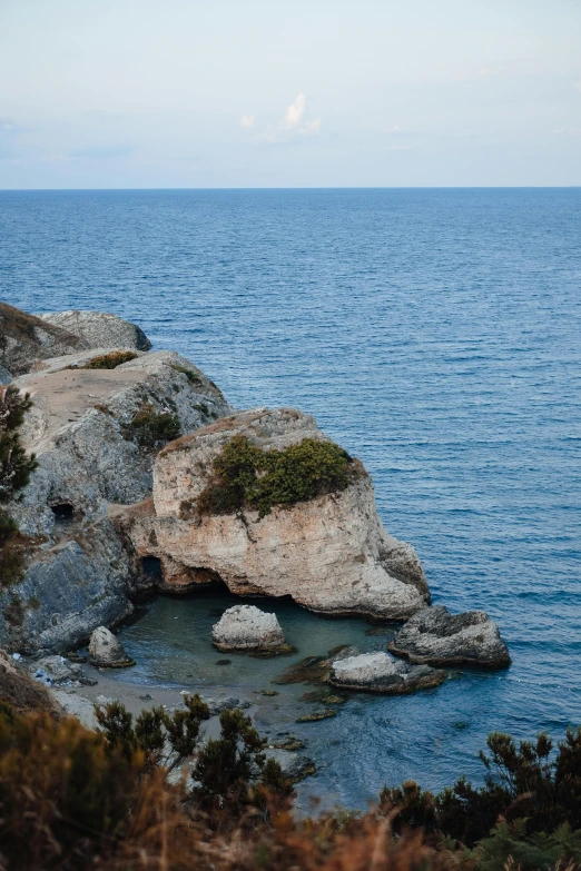 a large rock that is sticking out of the water