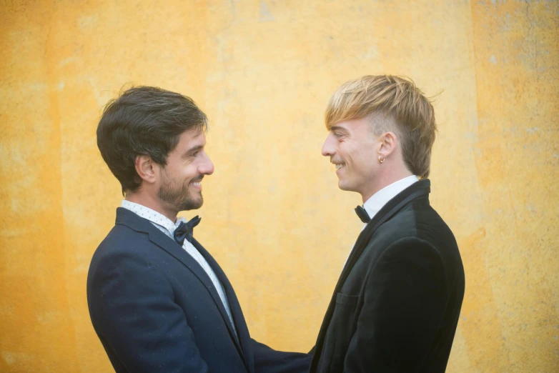 two men in suits standing next to each other