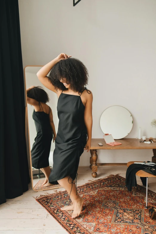 woman standing in front of mirror looking into a room