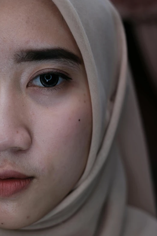 a close up of a woman wearing a scarf