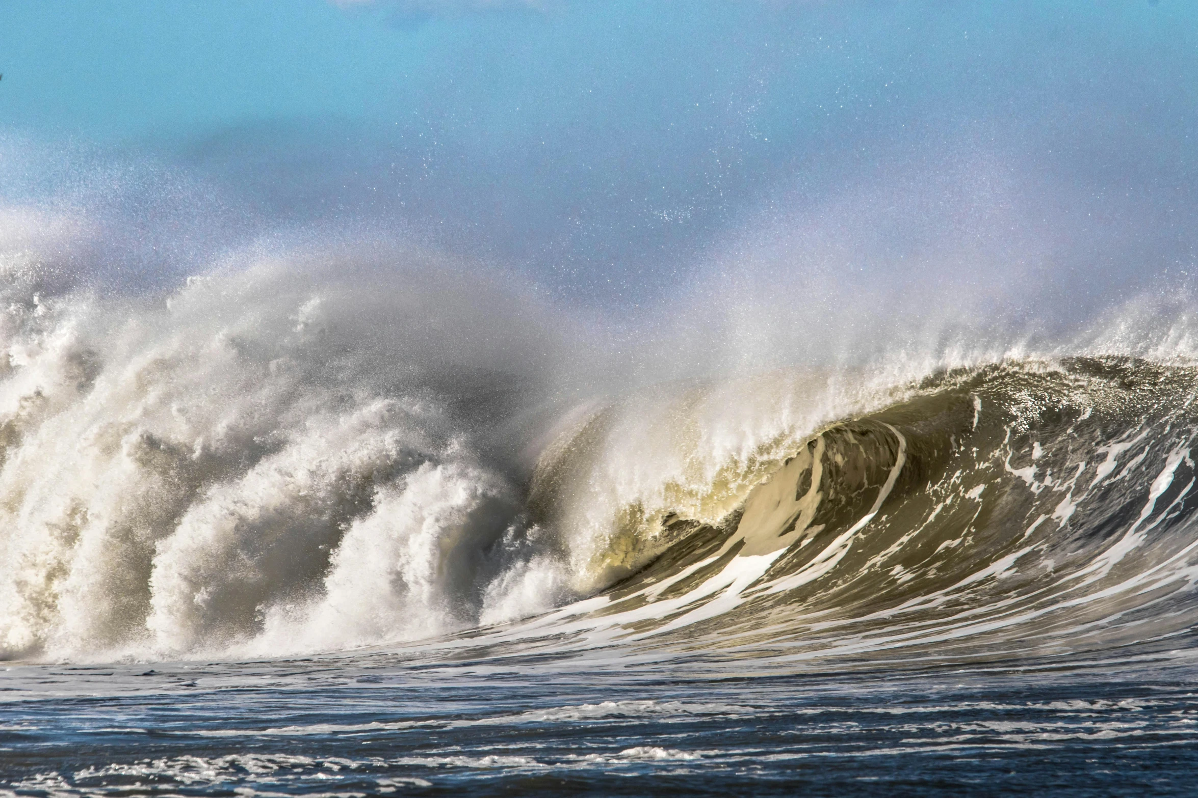 a big wave breaking in to the sea