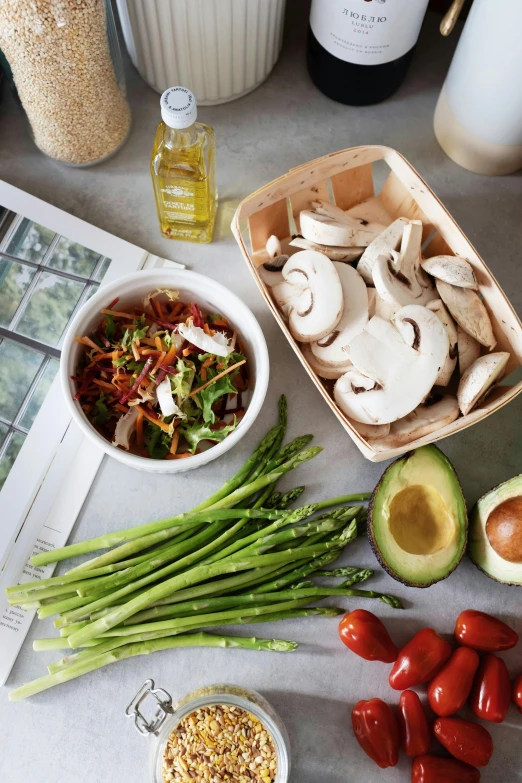 a table with vegetables, nuts and a bottle of wine