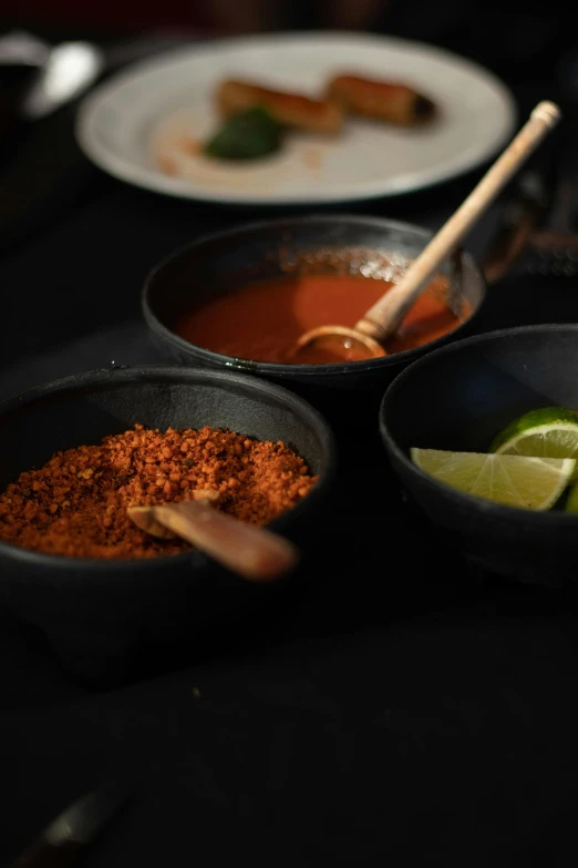 two plates and three bowls with different foods