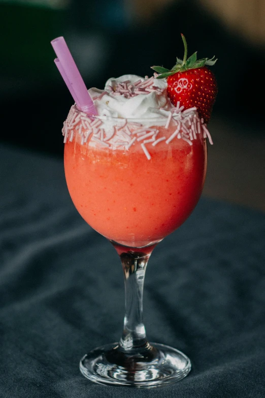 a pink drink with a strawberry on top