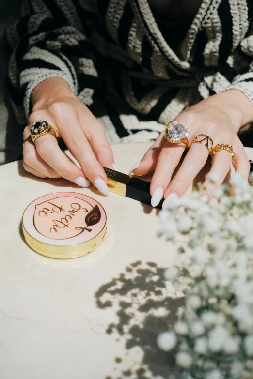 a women's hands are holding a lighter and a ring