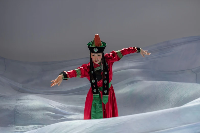 a woman is dressed as a costumed queen standing in a snow storm