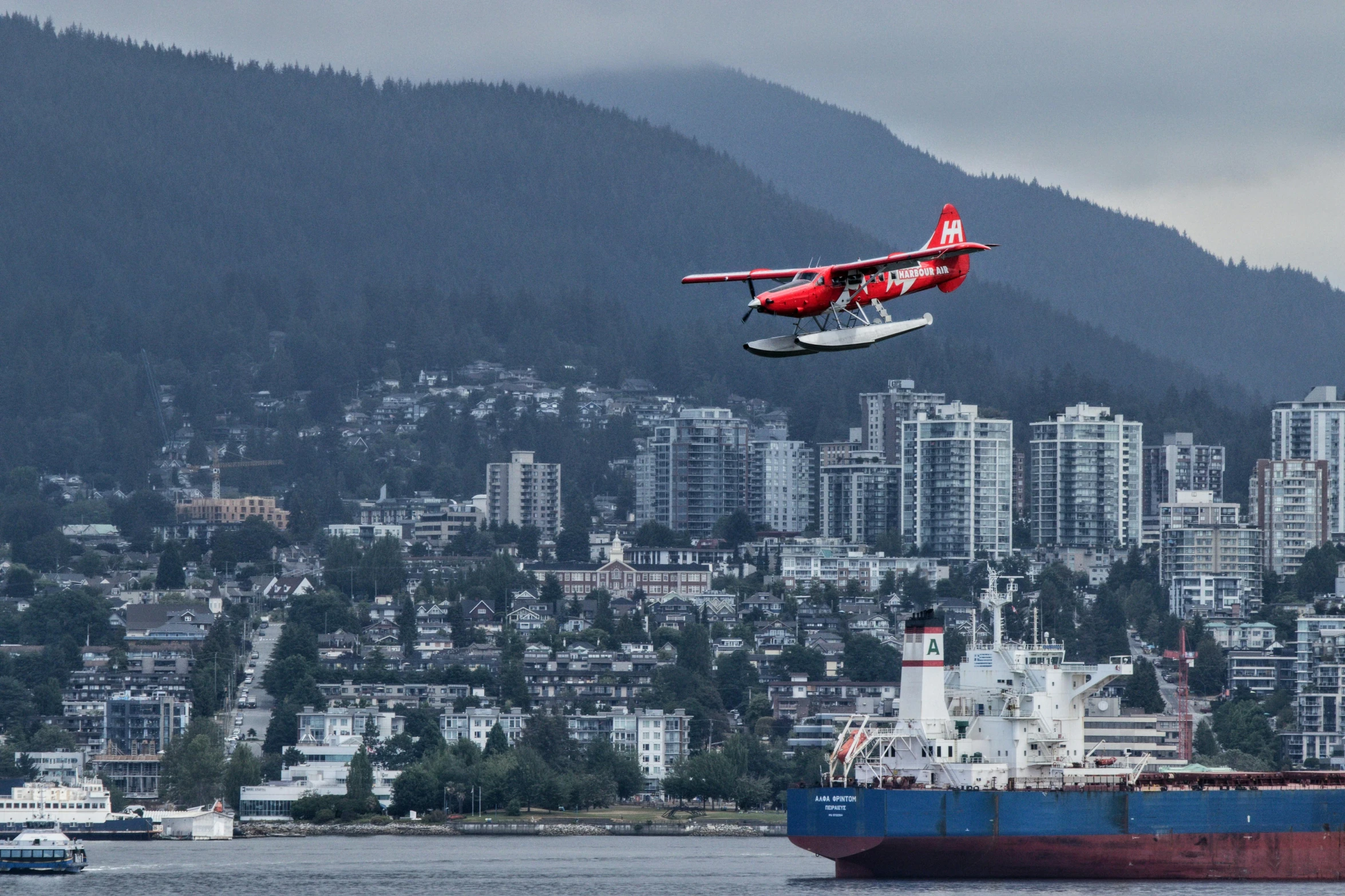 the plane is flying low above the water