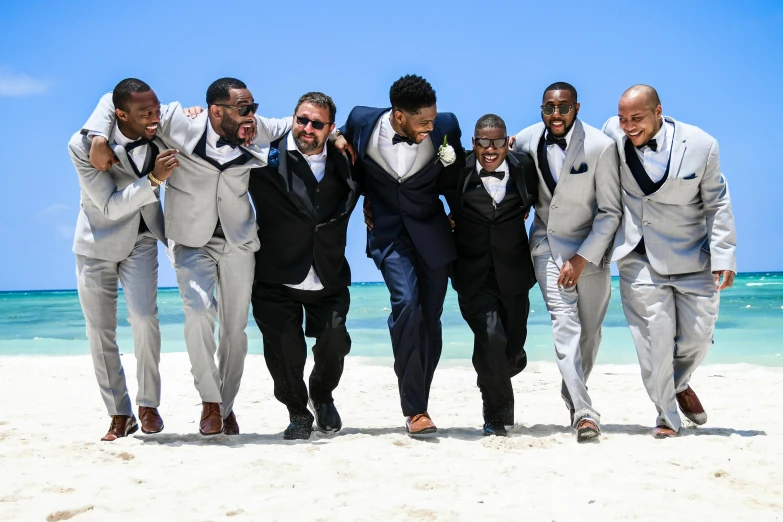 a group of men standing on top of a beach