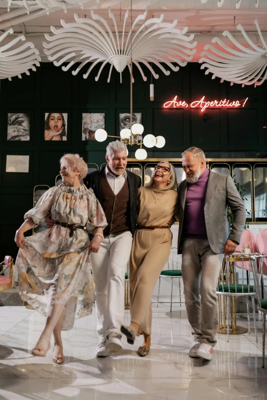 three older men and one old woman are standing outside a fancy shop