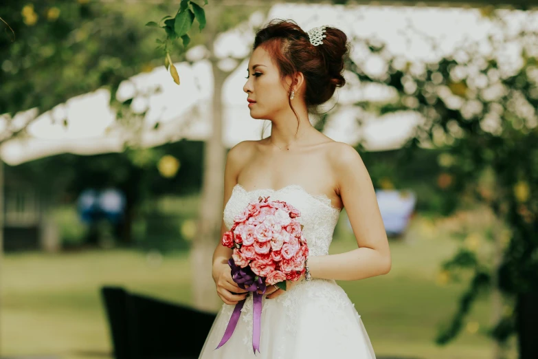 a beautiful asian bride with her bouquet in hand