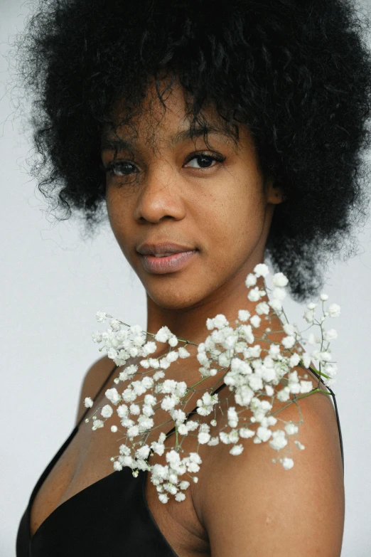 an african woman with flowers in her neck