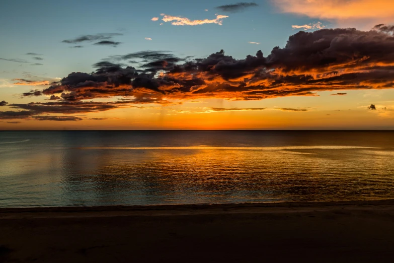 the sun setting over a body of water