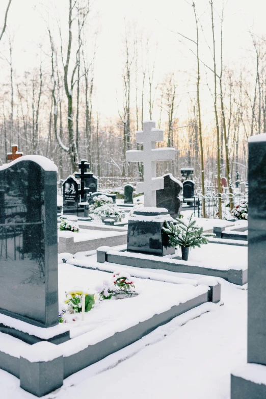 a snowy graveyard with crosses on the ground
