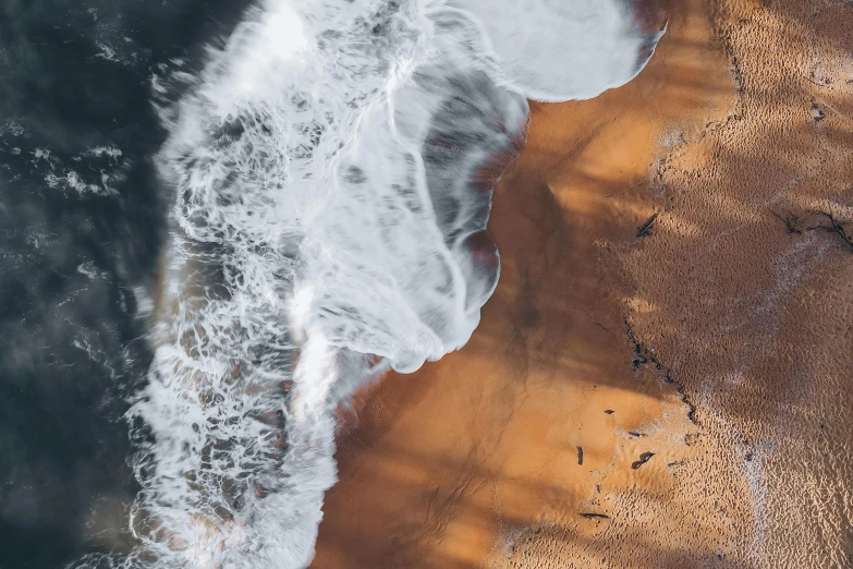 aerial pograph of waves coming in on the beach