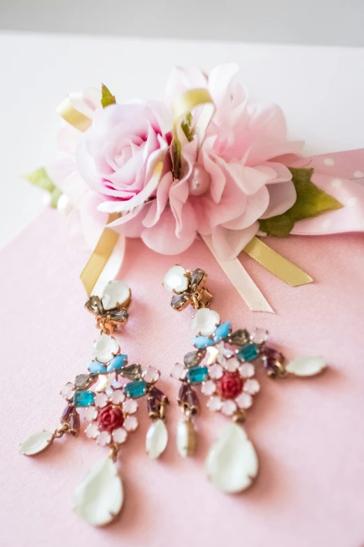 a close up of two flower and earrings