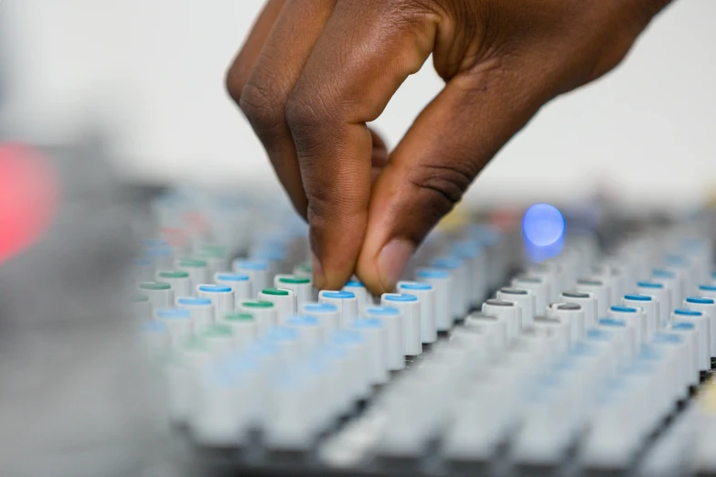 the hand is touching a sound board as it rests on a desk