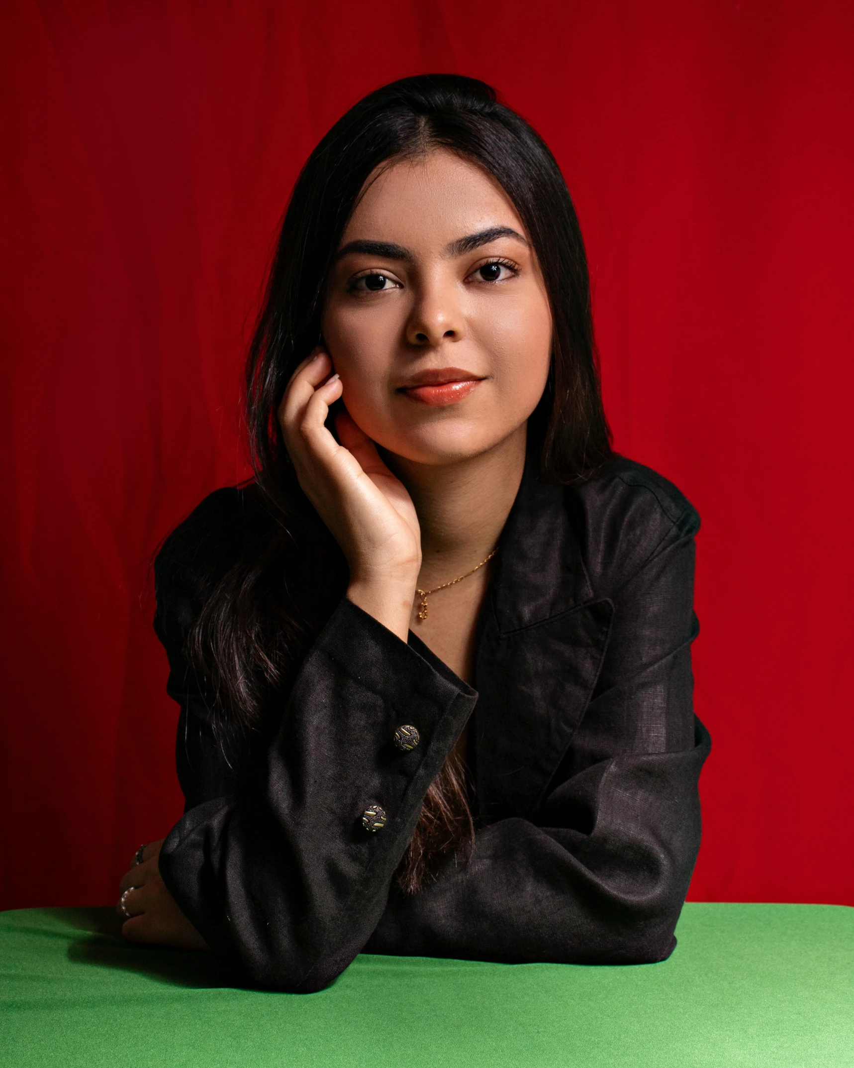 a girl wearing a black jacket posing for a po