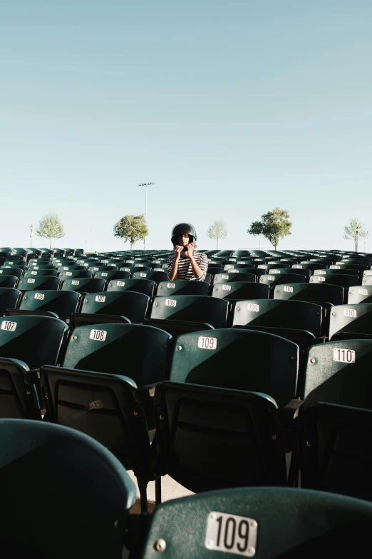 woman in a stadium standing on the stadium seats