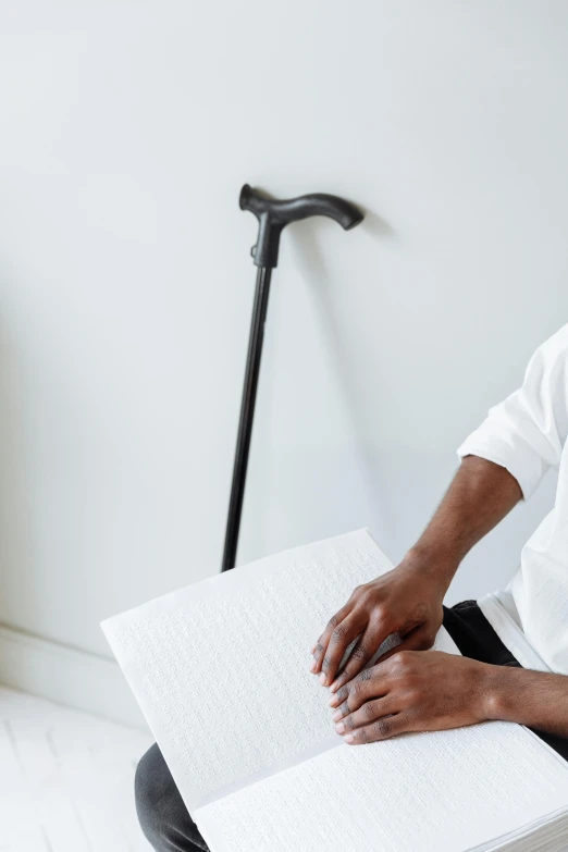 a person holding a book with the corner open