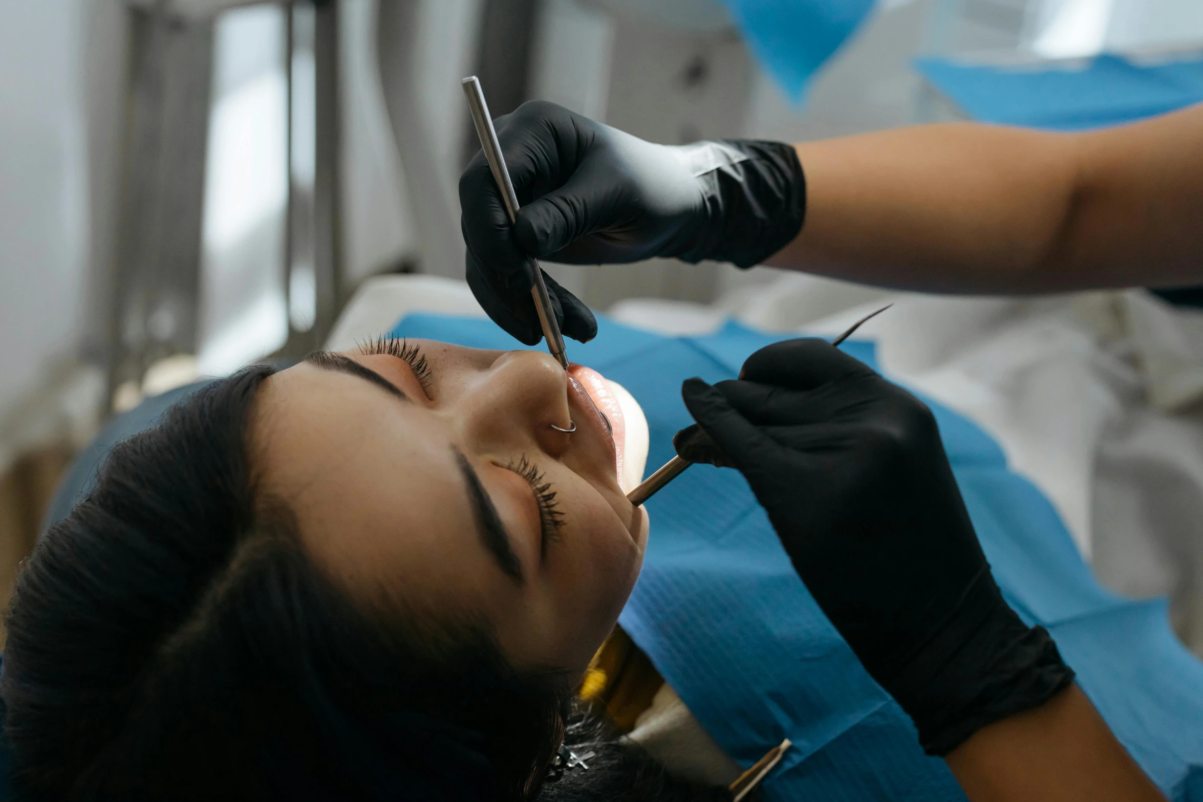 a woman being pographed at the dental exam