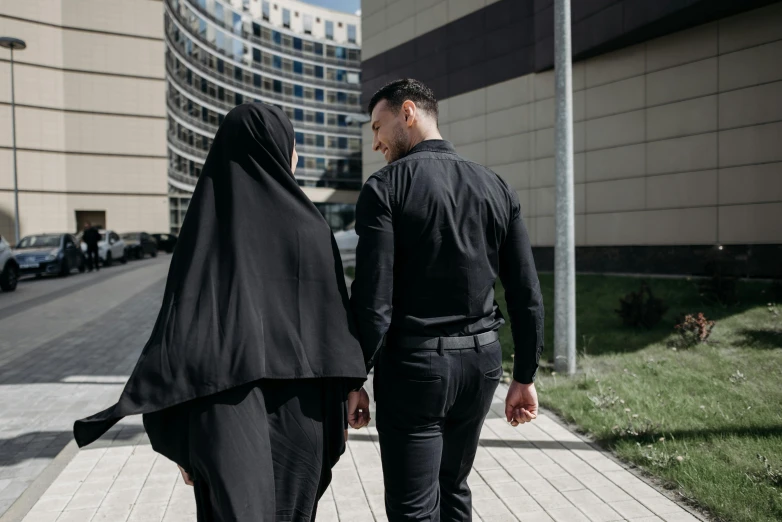 two men in black dressed in black