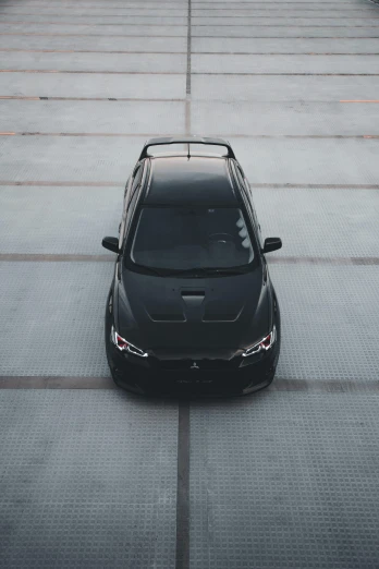 black car on pavement with gray floor