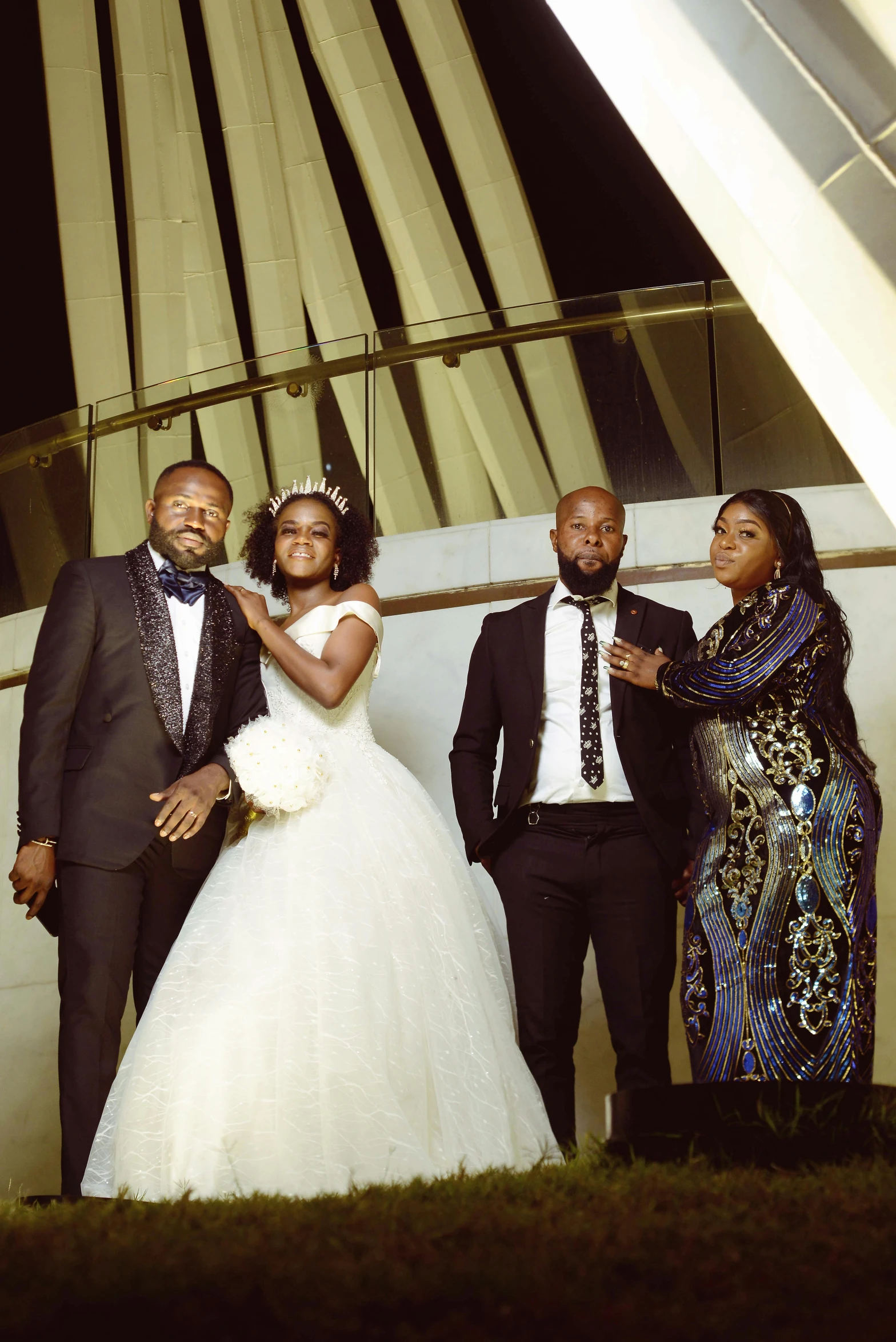 a couple pose with their bridal party mates