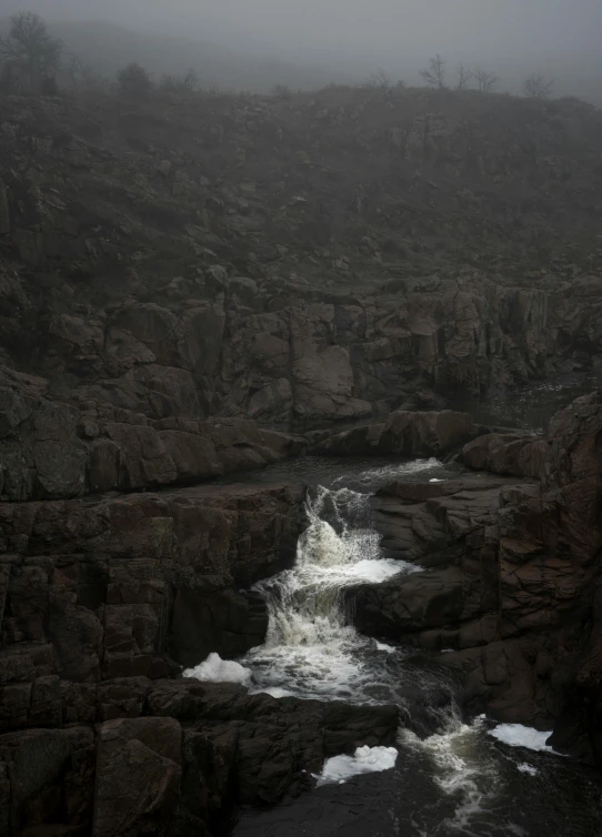 some water with rock cliffs and some trees