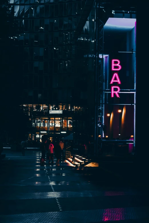 people walking on a street at night in the city