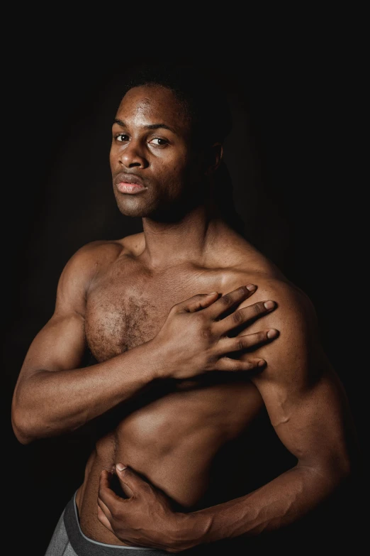 a man with chest pain and a black background