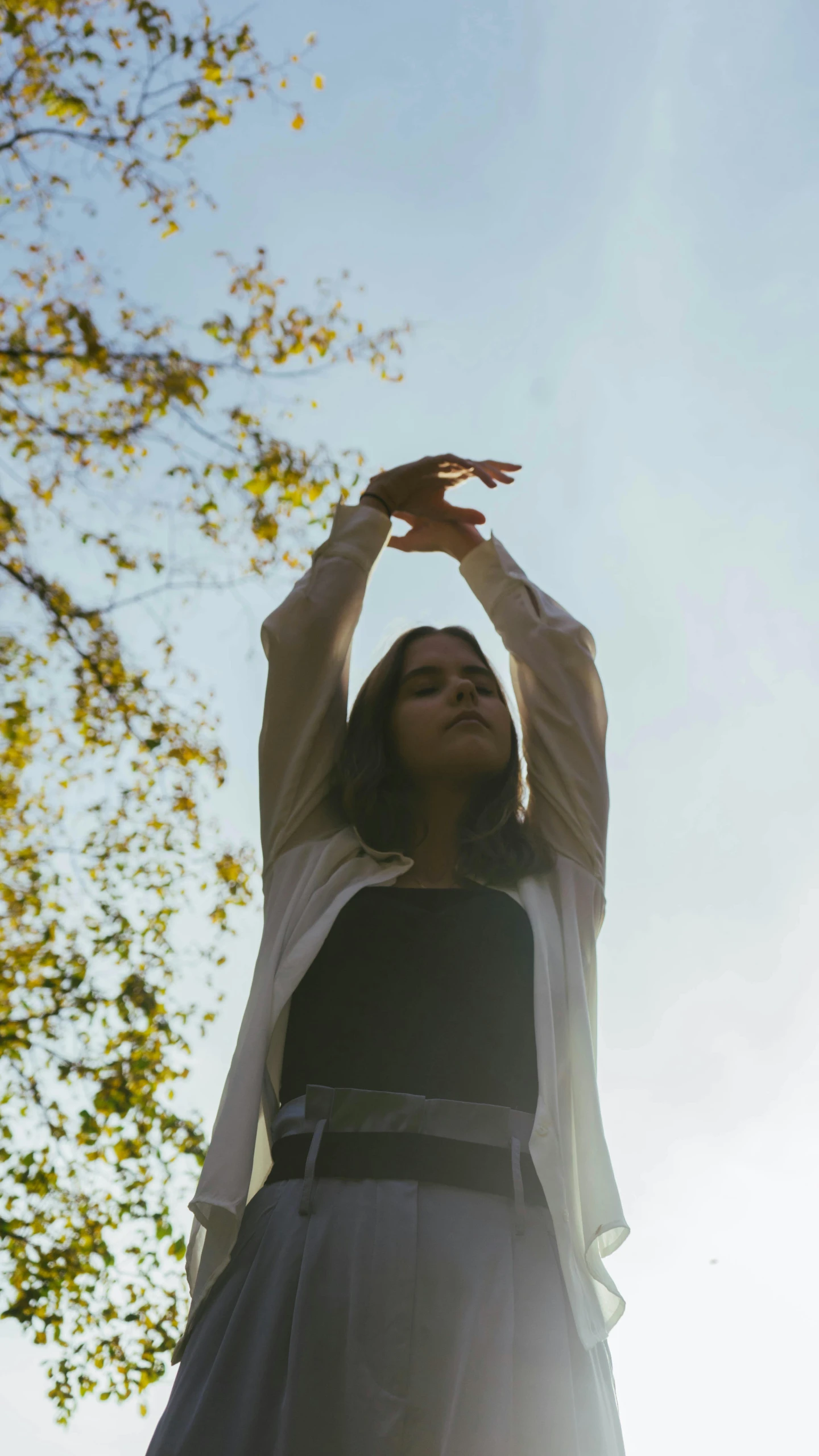 a woman with her arms up in the air