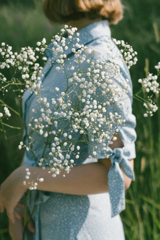 there is a woman that is holding a bouquet of flowers