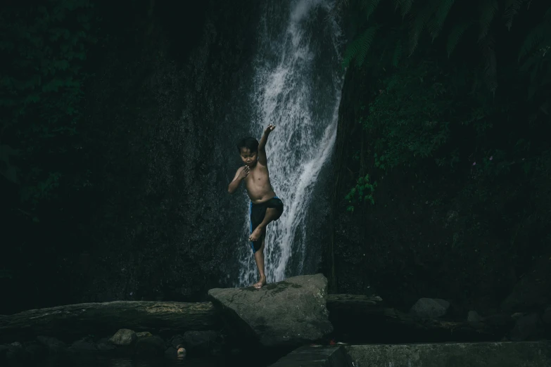 a young person standing in the midst of water