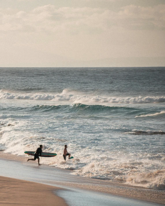 people are standing at the edge of the ocean