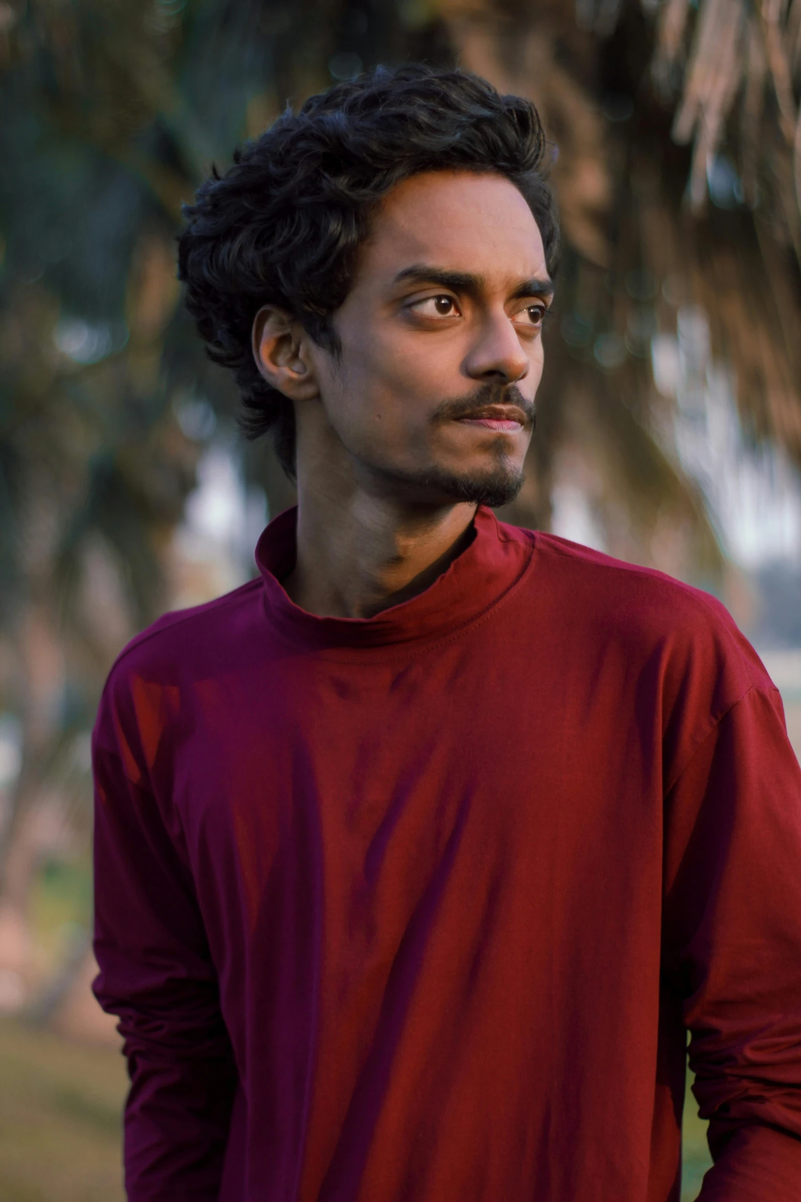 a man in a red shirt poses for a po