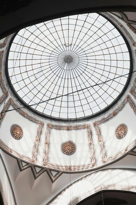 an intricate ceiling in the dome of a building