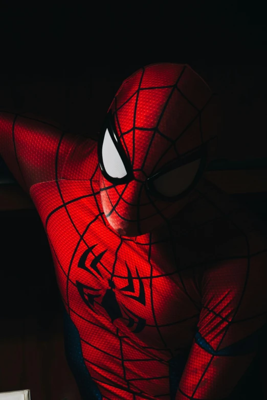 the face of a man is glowing through the spider - man