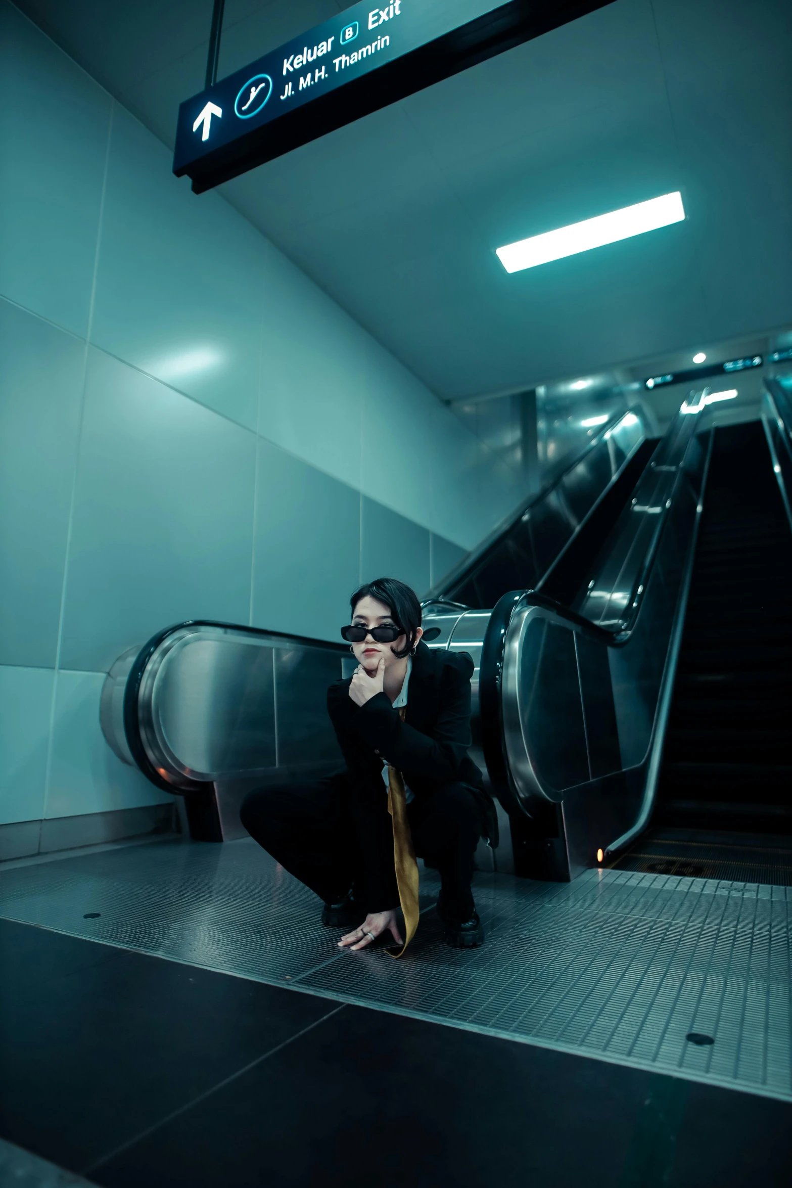 a woman kneeling on the floor of a building while holding her phone