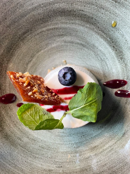 blueberry, raspberry sauce, and whipped cream in a bowl