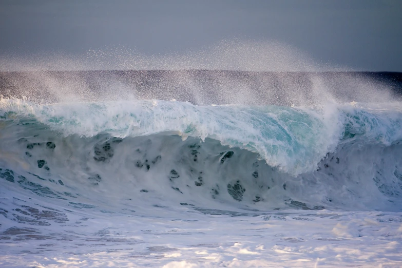 the ocean is turbulent as waves crash in front of it