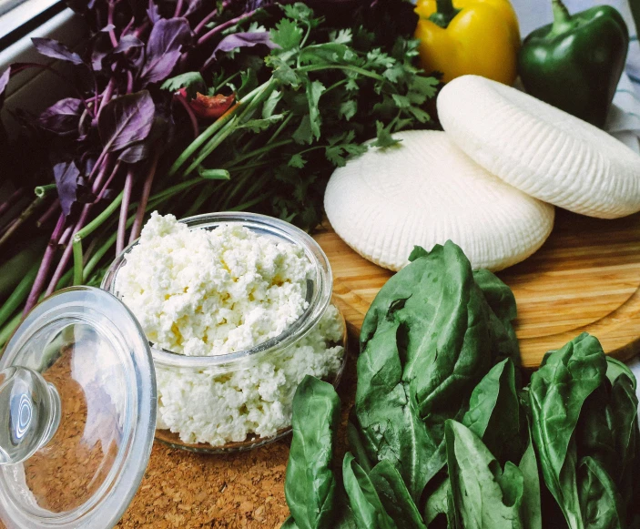 some veggies and ingredients are sitting on a  board