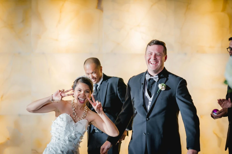 a smiling couple and their grooms in a po