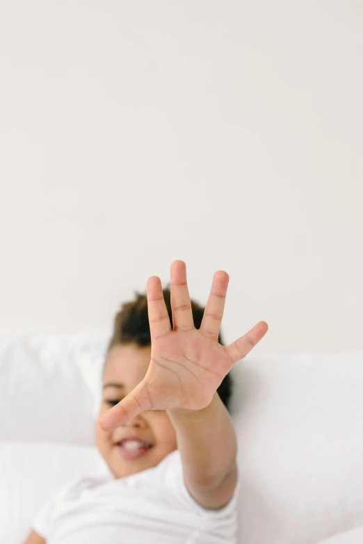 a child's hand raised up with their hand in the air