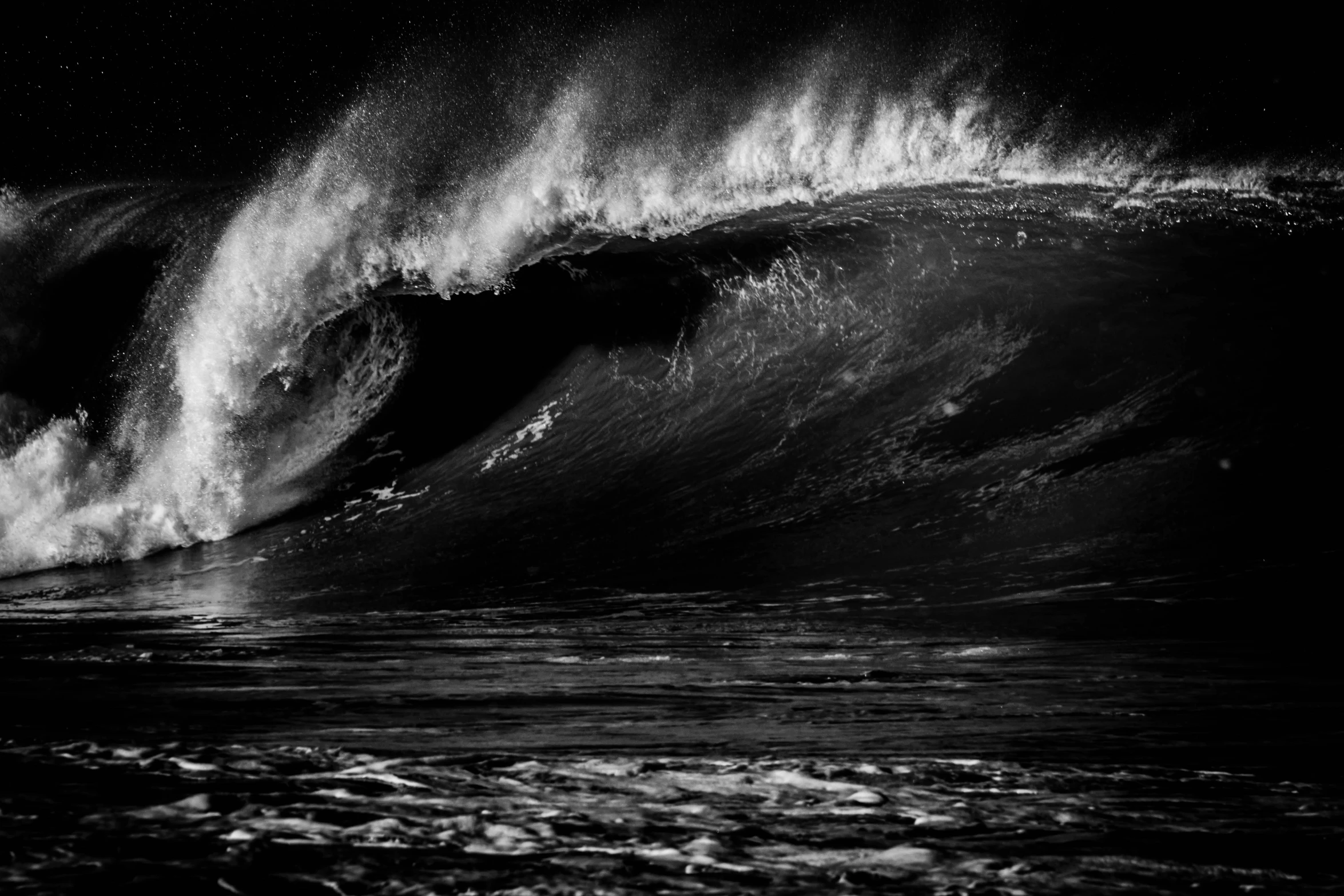 a surfer rides the crest of a huge wave