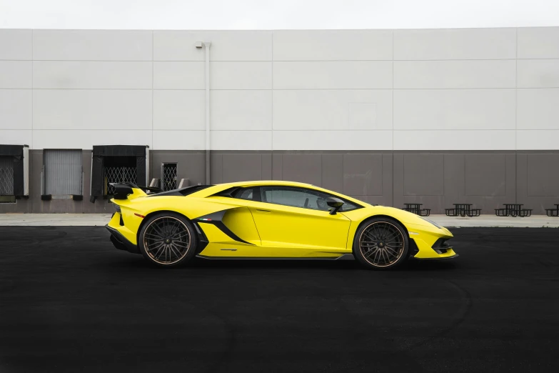 this is a yellow sports car on a black road