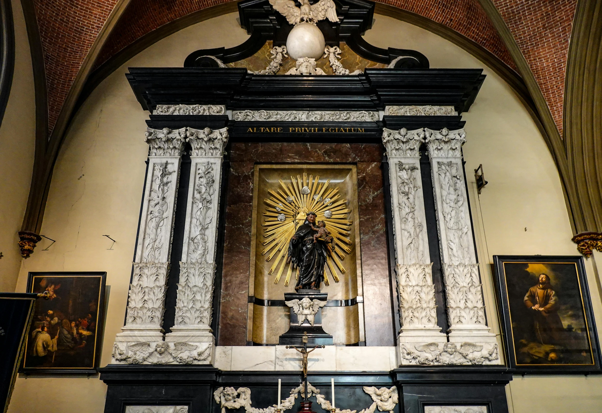 a statue in a cathedral with a cross