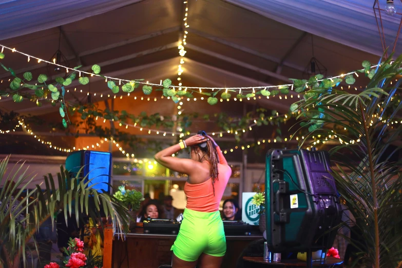 a woman in a short romter dancing in front of a crowd