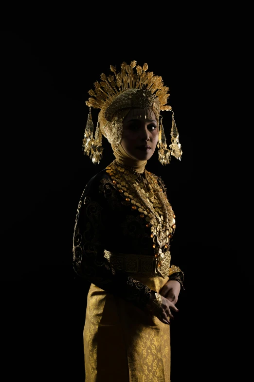 a girl wearing golden dress and a crown