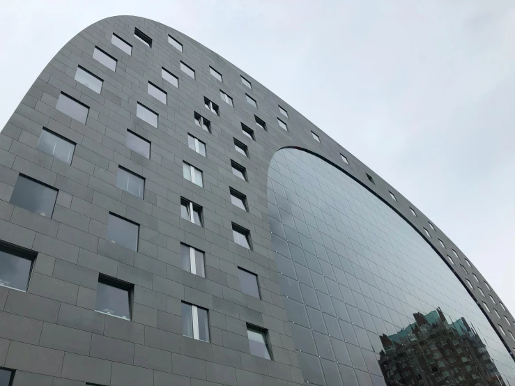 a tall building with multiple windows and a sky background