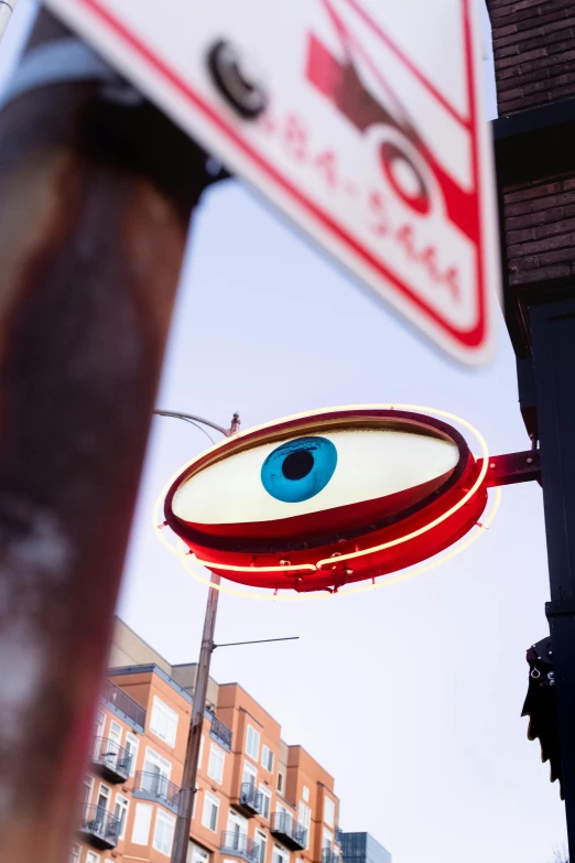 a no parking sign that has blue eyes on it